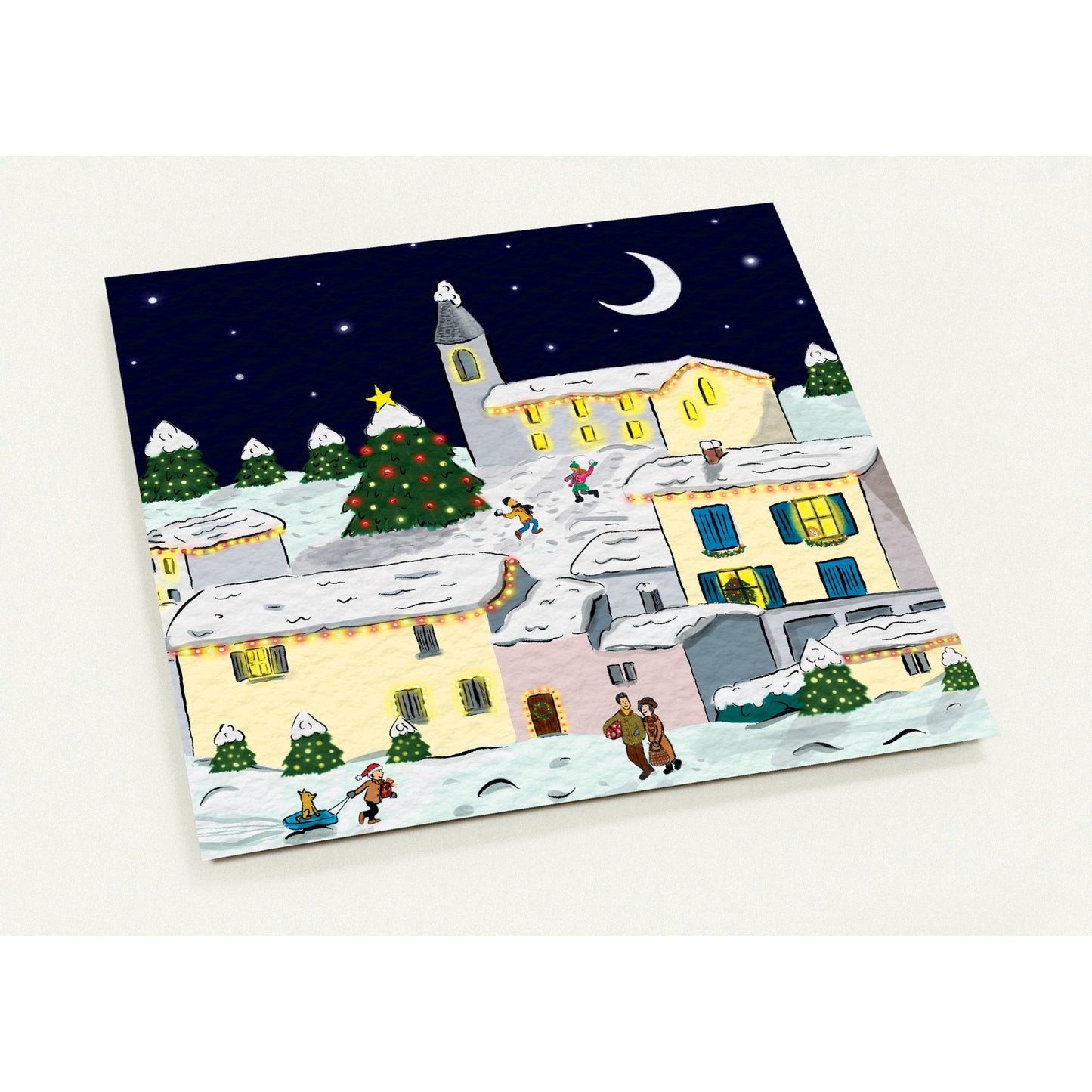 Cosy French village Christmas card featuring charming winter scene with snow-dusted buildings and festive lights, pack of 10 with envelopes