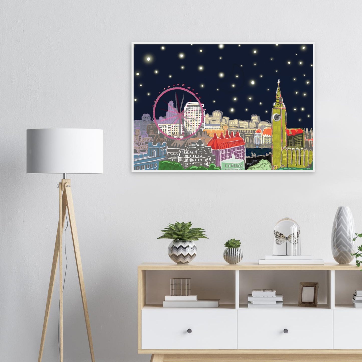 Starry London Skies art print showing iconic London landmarks under a magical starry night sky in wooden frame on white lounge wall